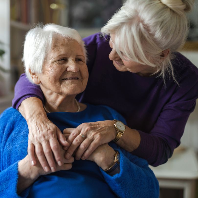Older lady smiling with caregiver
